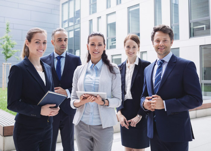 Professional team standing together in an office.
